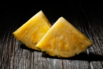sliced pineapple on wood background