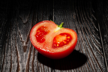 sliced red tomato on wood background