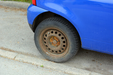 Wheel of a passenger car without a hubcap with a rusty steel rim