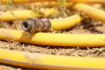 yellow water hose on the ground, high pressure water hose