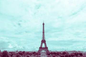 sight of Eiffel Tower in Paris at summer toned in aqua and purple