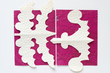 decorative cut paper shapes (thistle leaf and finial) on magenta pink and white paper