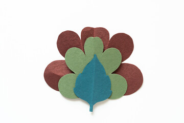 blue, green, and red brown paper shapes (leaves) isolated on a white background