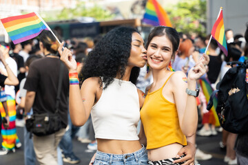 Portrait of Happy loving homosexual lesbian LGBT couple kissing at city streets. LGBT and Pride...