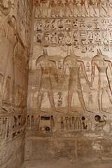 Inscriptions on the walls of the mortuary temple of Medinet Habu in Luxor in Egypt