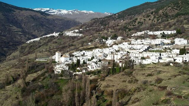 Aerial view above the beautiful villages of Capileira and Bubi&oacute;n in the gorge of the Poqueira in Andalusia Spain	