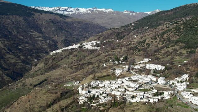 Aerial view above the beautiful villages of Capileira and Bubi&oacute;n in the gorge of the Poqueira in Andalusia Spain	