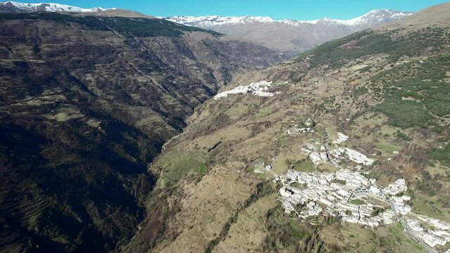 Aerial view above the beautiful villages of Capileira and Bubi&oacute;n in the gorge of the Poqueira in Andalusia Spain	