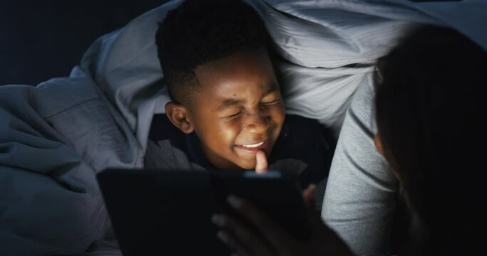 Laughing, night and mother and child with a tablet for a cartoon, gaming or a movie in bed. Funny, happy and an African mom with a boy kid and technology in the dark in a bedroom for a video or games