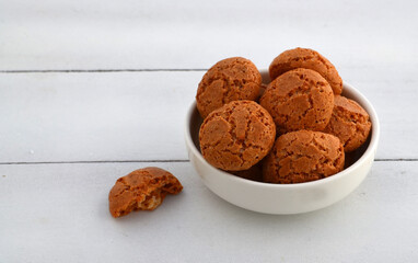 Amaretti Italian almond cookies on a white background with copy space.Famous amarettini cookie biscuits.Delicious Christmas pastry popular in Italy.Selective focus.