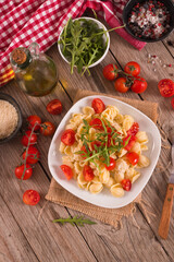 Orecchiette pasta with arugula and tomato. - 611723685