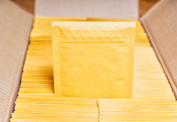 Cardboard Box Filled with Yellow Mailers