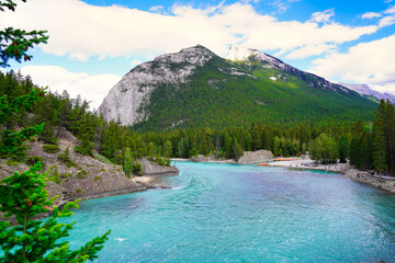 Naklejka na ściany i meble The Bow river curves past the backside of Mount Rundle in this view from Banff town in the Canada rockies