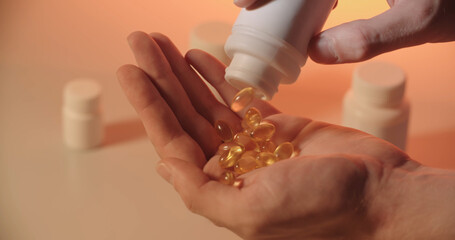 Man taking pills from a tablet can, representing modern addiction to drugs, vitamins and medicine - close up 