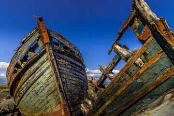 Fototapeta na wymiar Salen's 3 ships - iconic boat wrecks on the shore line on the Isle of Mull