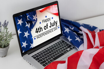 American flag on the desk and laptop screen. Fourth of July Concept