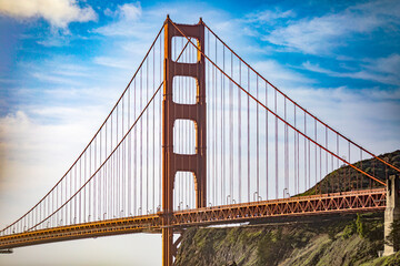 Golden Gate Bridge in the bay of the city of San Francisco, in the state of California in the USA, under a blue sky and beautiful clouds. Concept America.
