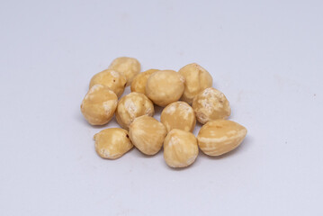 Obraz premium Beautiful hazelnuts are seen harvested on a white background and ready to be consumed.