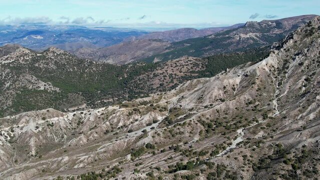 Aerial fly over view above the mountains and valleys in the Sierra Nevada mountains in Spain	
