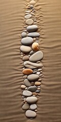 Fototapeta na wymiar Art de galets minimaliste avec une série d'empreintes de pas de galets ressemblant à des rochers dans le sable menant à l'océan