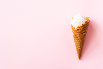 Strawberry ice cream. Ice cream cone top view on pink.