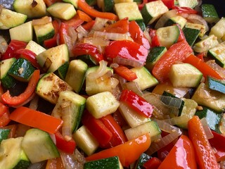 Colorful Mediterranean vegetable dish with diced peppers, zucchini and onions