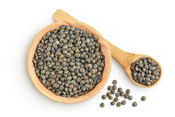 raw french green lentils in wooden bowl isolated on white background. Top view. Flat lay