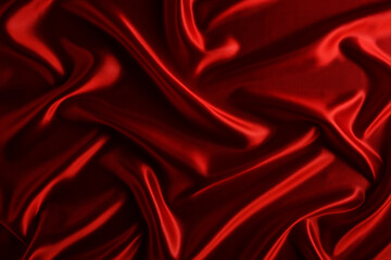 Abstract background made of red silk wavy fabric.
