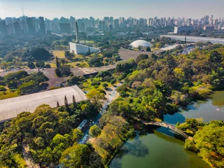 Tuinposter Aerial view of Sao Paulo city, next to Ibirapuera Park. Prevervetion area with trees and green area of Ibirapuera park in Sao Paulo city, Brazil. © Paulo