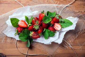 strawberries and green leaves on the table