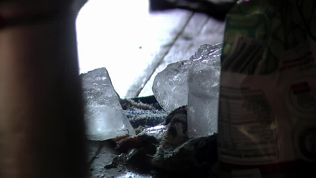 Man Breaking Ice Block in Kitchen. Close Up.  