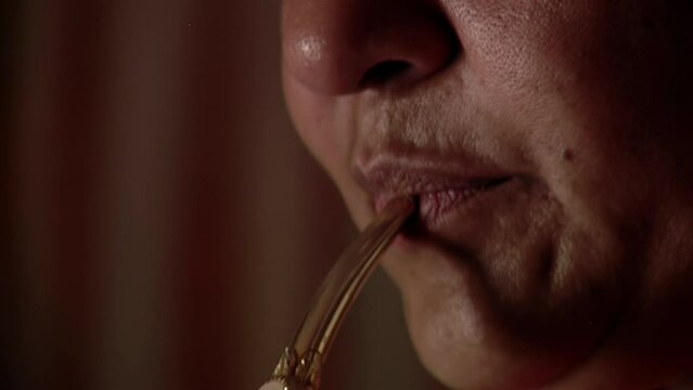 A Woman Drinking Yerba Mate Infusion at Her Home. Close Up.