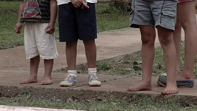 Poor Children Standing on a Street in Corrientes Province, Argentina. Low Angle View. 