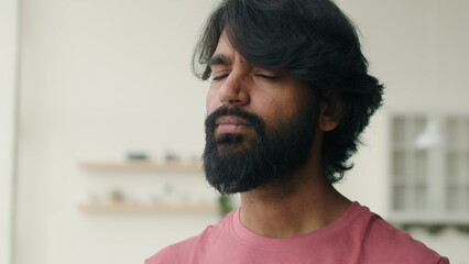 Fototapeta premium Pensive Arabian muslim man Indian ethnic guy in home kitchen bearded businessman look aside think solution portrait satisfied homeowner renter apartment looking at camera smiling dental toothy smile