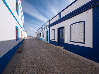 Street with blue and white houses in the historic village of Cacela Velha, Portugal
