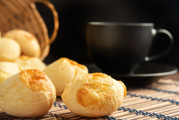 Cheese bread, Basket with cheese bread lying on a wooden woven mat and accessories, dark...