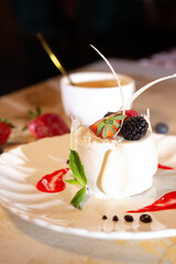 a beautiful fresh white dessert in a restaurant on the table. original dessert serving close-up