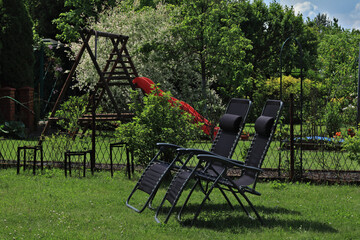 Black sun loungers in the garden
