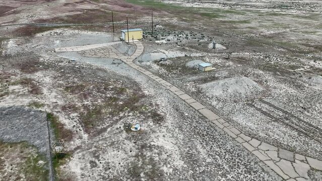 Aerial abandoned secret missile test site Utah desert slide 1. Military solid fuel rocket test facility. Abandoned weapon bunkers and missile buildings. Secret Cold War munitions. Nuclear missile.