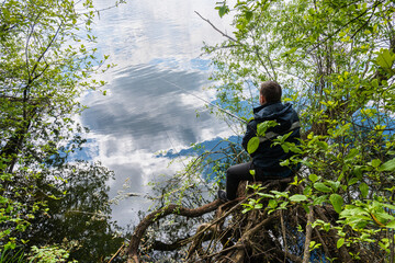 A man on the lake catches fish