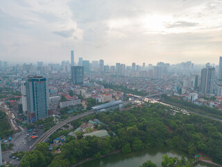Fototapeta premium Aerial view of Hanoi Downtown Skyline with green garden park, Vietnam. Financial district and business centers in smart urban city in Asia. Skyscraper and high-rise buildings.