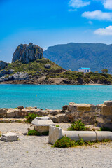 Ruins of the Basilica St. Stefanos in front of beautiful Island Kastri - beautiful coast scenery of...