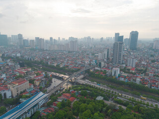 Naklejka na ściany i meble Aerial view of Hanoi Downtown Skyline with green garden park, Vietnam. Financial district and business centers in smart urban city in Asia. Skyscraper and high-rise buildings.
