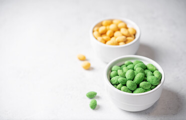 Wasabi and cheese peanuts in bowls