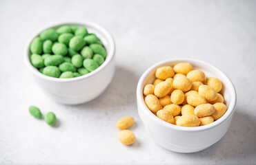 Wasabi and cheese peanuts in bowls