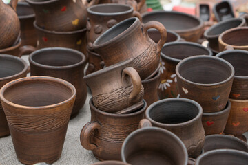 Fototapeta na wymiar Different examples of tradtional ukrainian clay pottery: pots, jars, vases, cups and bowls.