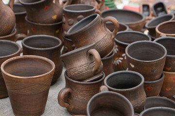 Different examples of tradtional ukrainian clay pottery: pots, jars, vases, cups and bowls.