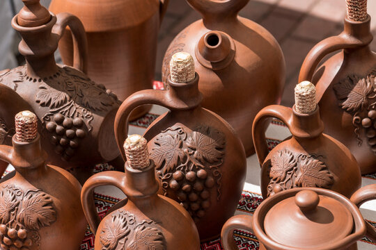 Different examples of tradtional ukrainian clay pottery: pots, jars, vases, cups and bowls.