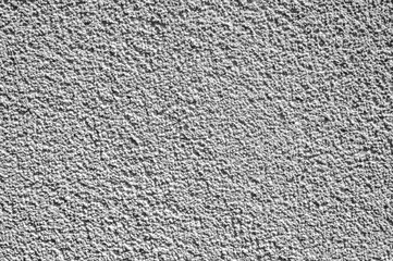 Weißer, strukturierter Putz einer Hauses an der Fassade