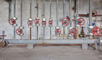 Close-up at pipeline valve which is using to control production process in the oil refinery plant....